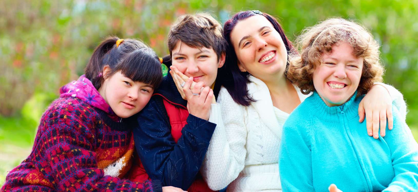 four ladies hugging next to each other