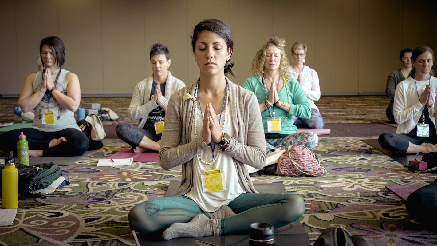 Ladies sitting cross legged in yoga class